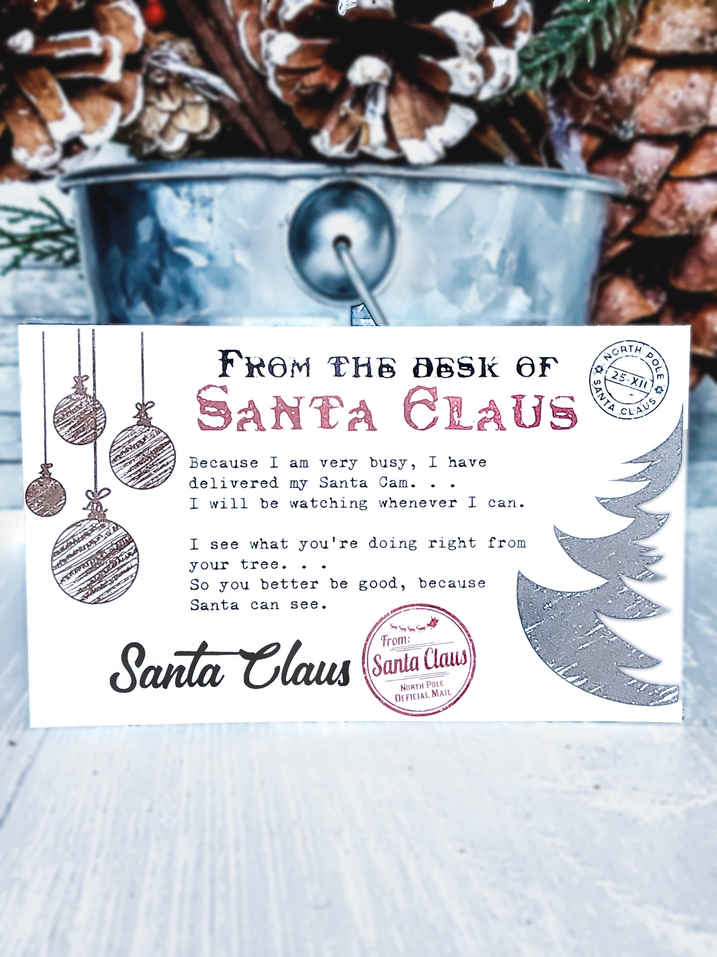 Handcrafted Santa Cam Ornament with a sparkling red finish, faux camera lens, and a letter from Santa Claus, perfect for adding magic to holiday décor.