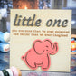 Light wood sign featuring the phrase "little one you are more than we ever expected and better than we ever imagined" with raised gray text and a pink elephant cutout at the bottom.