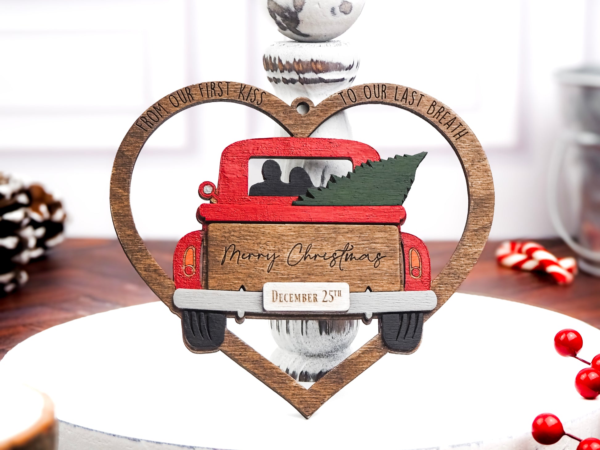 Handcrafted wooden "From Our First Kiss to Our Last Breath" ornament featuring a vintage red truck with a Christmas tree, framed in a heart, perfect for holiday décor and a romantic gift.