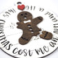 Close-up of a round ornament featuring a wooden gingerbread figure with a missing arm and leg. The surrounding text reads "Christmas Cost Me an Arm and a Leg," with a red heart detail at the top.