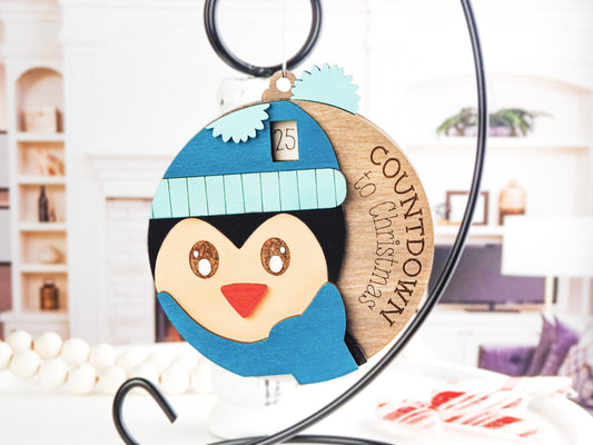 Handcrafted wooden Penguin Countdown to Christmas ornament featuring an adorable penguin with a winter hat and scarf, perfect for holiday décor and adding excitement to the Christmas season.