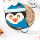 Handcrafted wooden Penguin Countdown to Christmas ornament featuring an adorable penguin with a winter hat and scarf, perfect for holiday décor and adding excitement to the Christmas season.