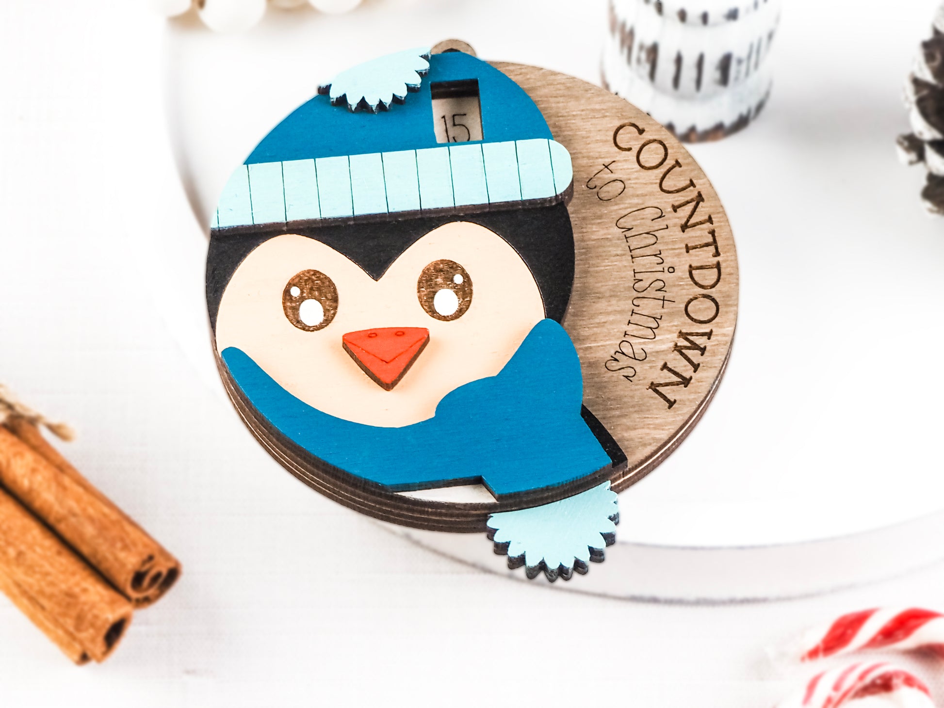 Handcrafted wooden Penguin Countdown to Christmas ornament featuring an adorable penguin with a winter hat and scarf, perfect for holiday décor and adding excitement to the Christmas season.