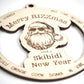 Close-up view of a wooden Christmas ornament featuring an engraved Santa wearing sunglasses with the text Merry Rizzmas and a Skibidi New Year. Trendy slang words encircle the design, highlighting intricate laser-cut details on a white background.