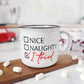 Campfire white ceramic mug with speckles and a black halo around the rim. The words Nice, Naughty and I tired are hand-painted with a check mark beside I tried is on one side. Nice and Naughty is painted in black and the checkmark and I tried is painted in red. The Nice, Naughty and I tried is hand-painted by Snuggle Up Co.