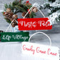 3 wooden hanging décor signs painted each in white, red and green are 2-inches in height and 6.25-inches in length.  Displaying the phrases Candy Cane Lane, North Pole and Elf Village in white. Hand-painted by Snuggle Up Co.