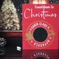 Red wooden sign with white lettering that reads Countdown to Christmas. The sign features a circular gold emblem with the words Santa Claus Approved around a central chalkboard area for writing numbers. The emblem includes silhouettes of Santa in his sleigh being pulled by a reindeer, with snowflakes decorating the design.